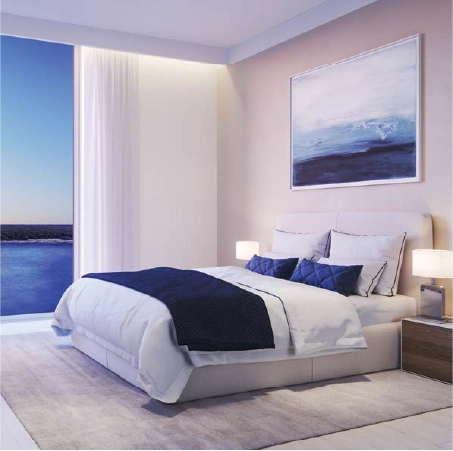 Open-plan living room with balcony views in Water’s Edge apartment, Abu Dhabi